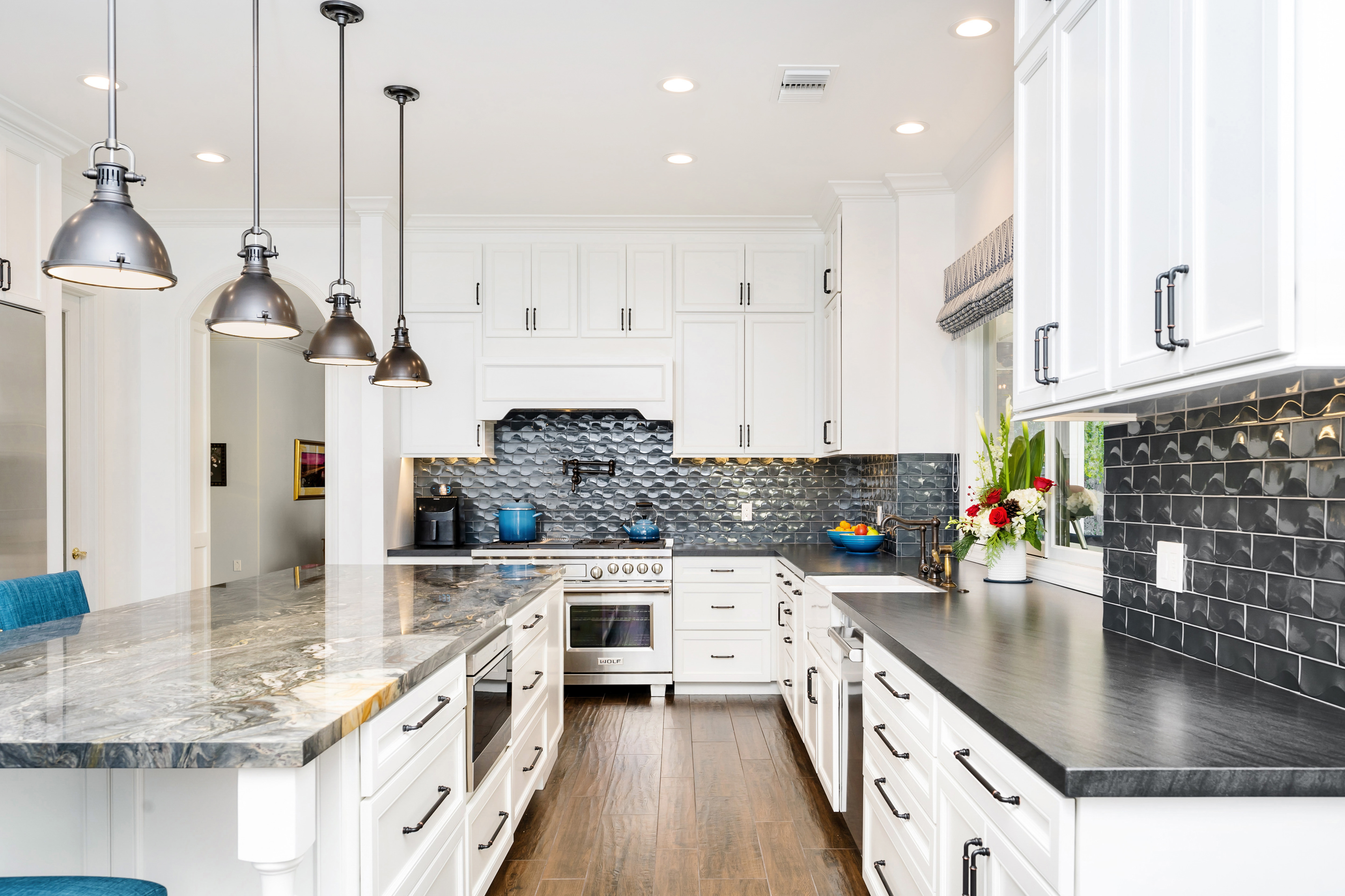 Open kitchen drawer showing organized pull-out storage in a renovated home