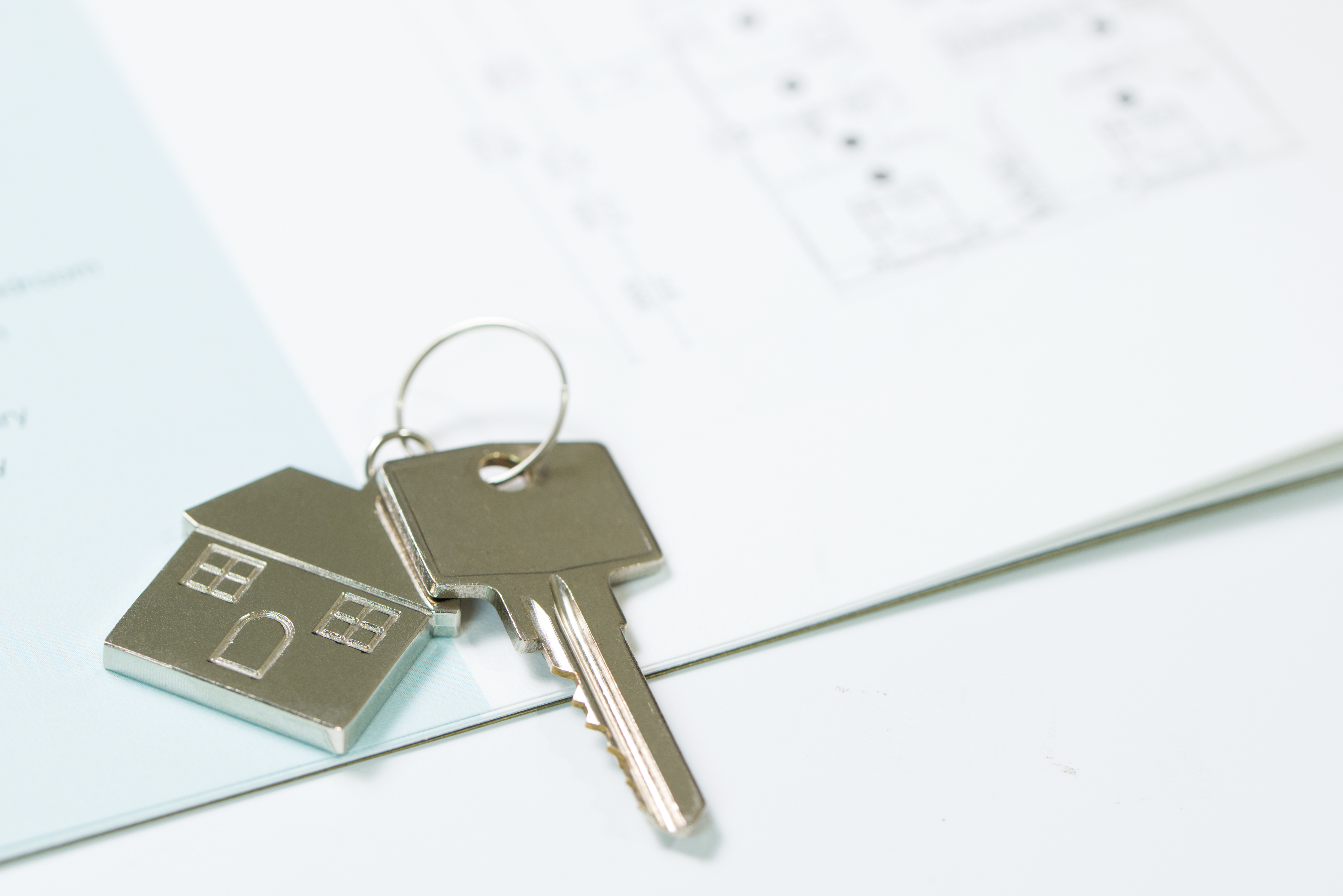 First-time homebuyers reviewing mortgage documents at a kitchen table